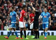 MANCHESTER, ENGLAND - MARCH 04: Marcus Rashford of Manchester United (L) is shown a yellow card by referee Kevin Friend during the Premier League match between Manchester United and AFC Bournemouth at Old Trafford on March 4, 2017 in Manchester, England.  (Photo by Julian Finney/Getty Images)